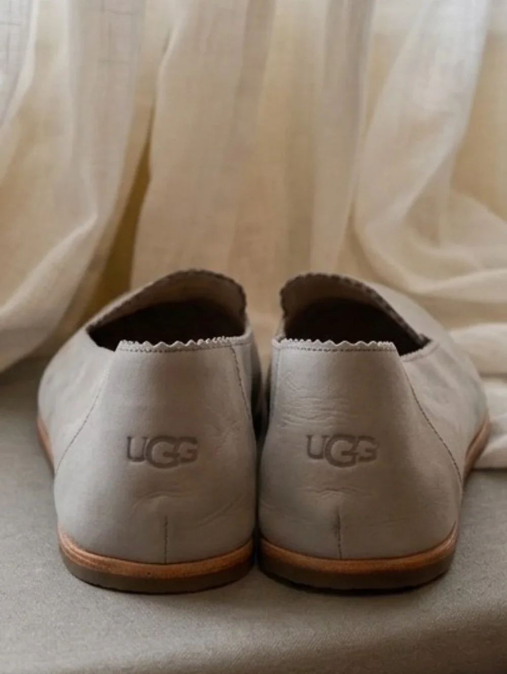 UGG Vista slip-on flats featuring a distinct scalloped edge detail.